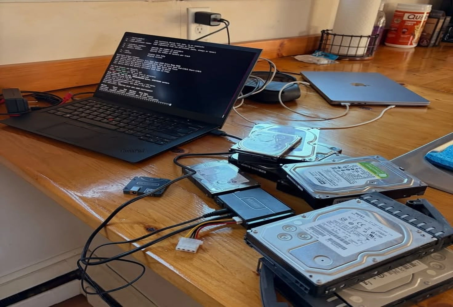 Professional data recovery service with hard drives, laptop, SSD, and data recovery equipment